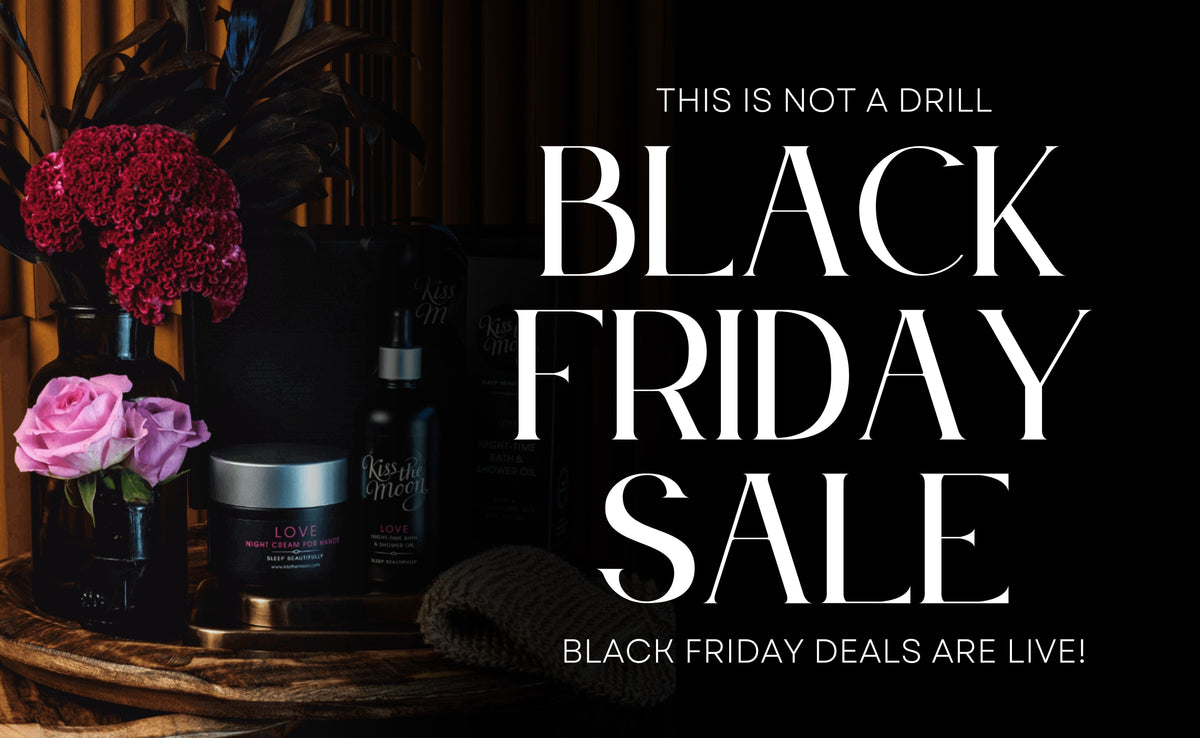 Promotional graphic for a Black Friday sale, featuring large white text on a black background with decorative flowers and several dark cosmetic or skincare bottles displayed on a wooden surface.